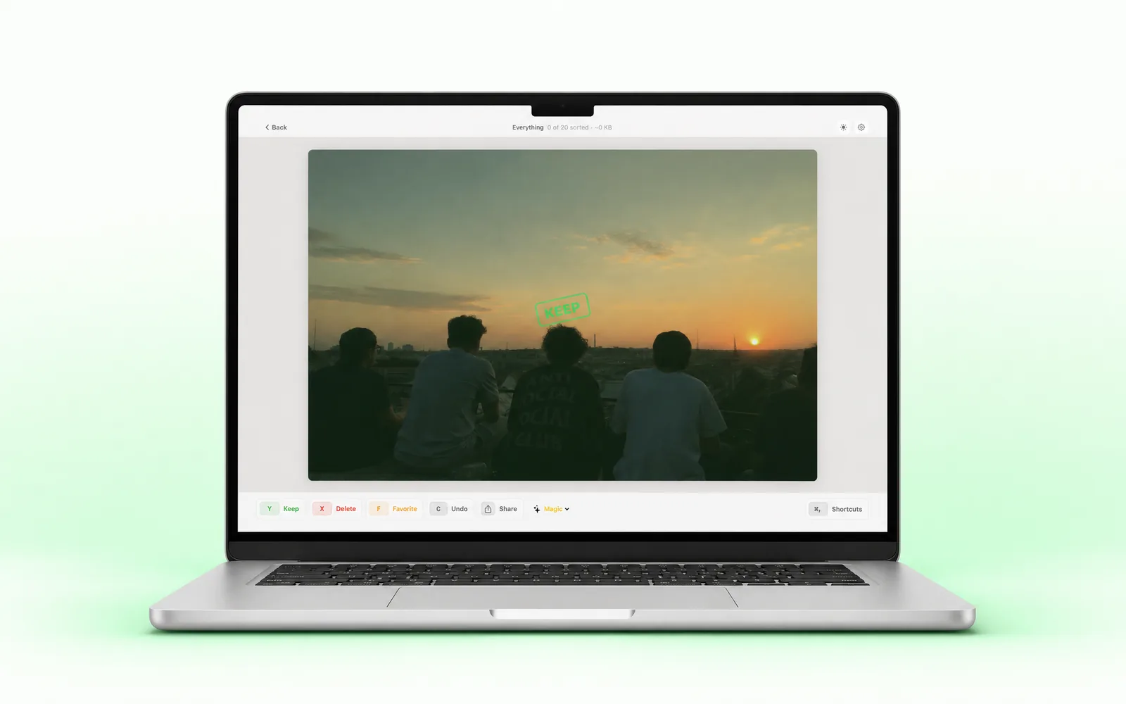 SwipePhotos running on a MacBook: a sunset photo mid-review with the KEEP stamp and the keyboard action bar